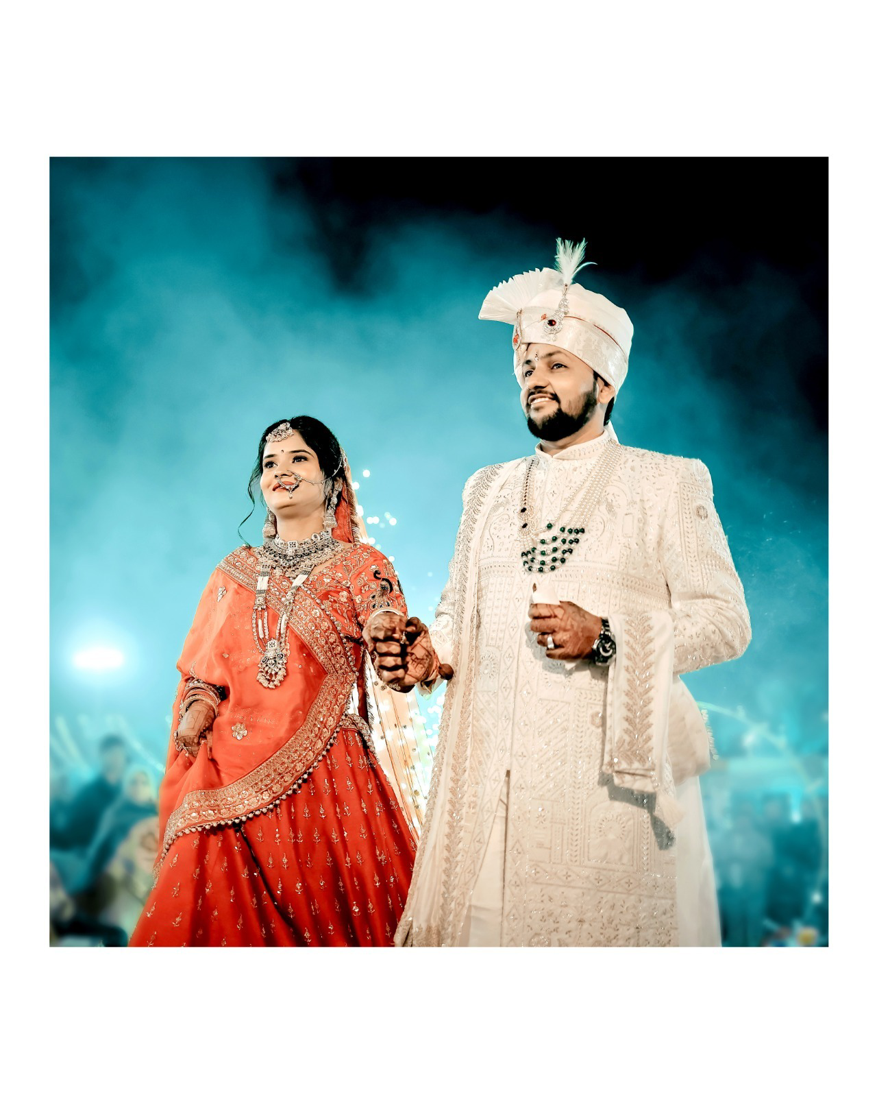 Jaanu and Priya walking together under teal stage lights at their wedding