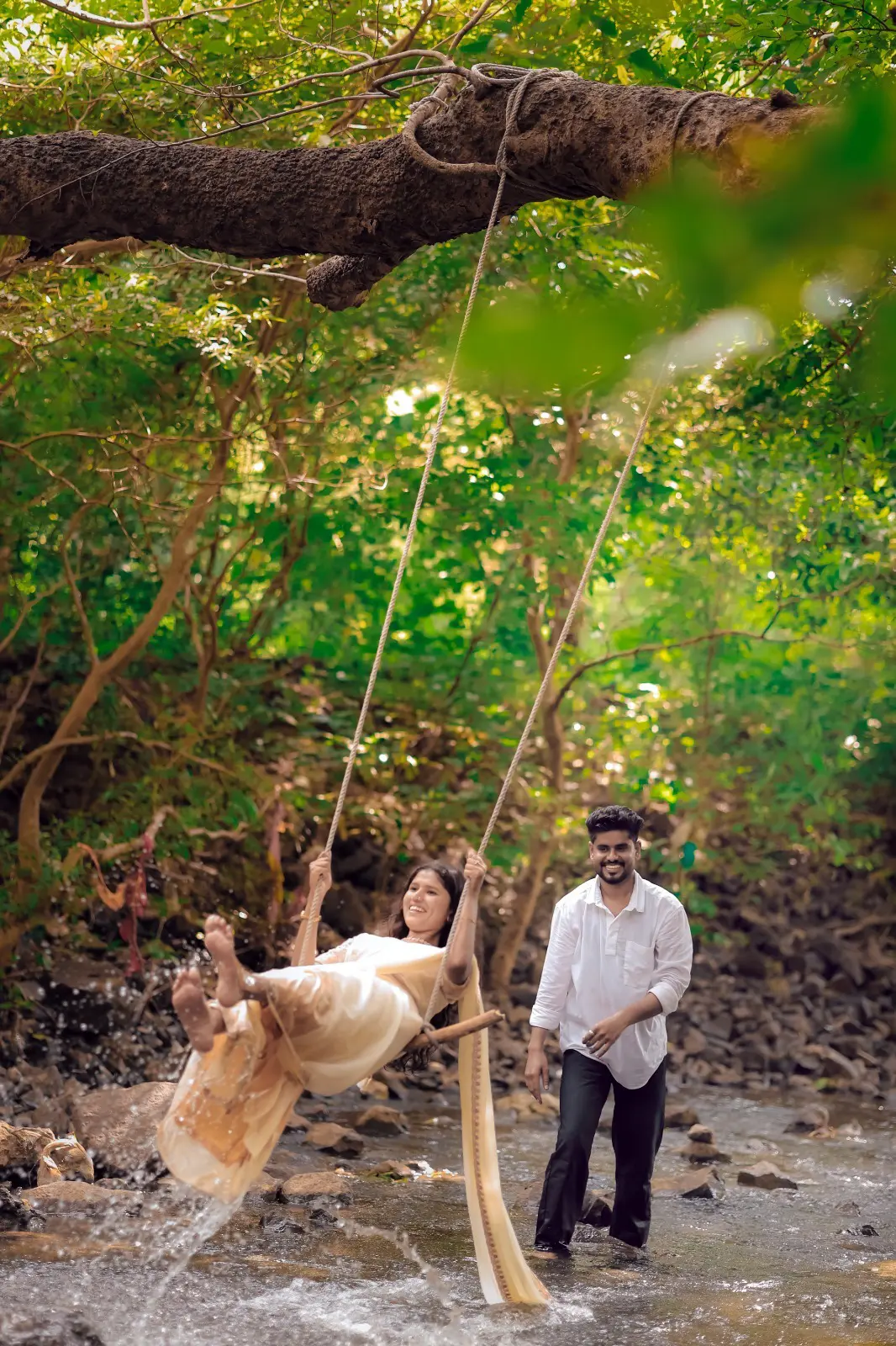 Ritik and Shivani enjoying their pre-wedding shoot by a forest stream